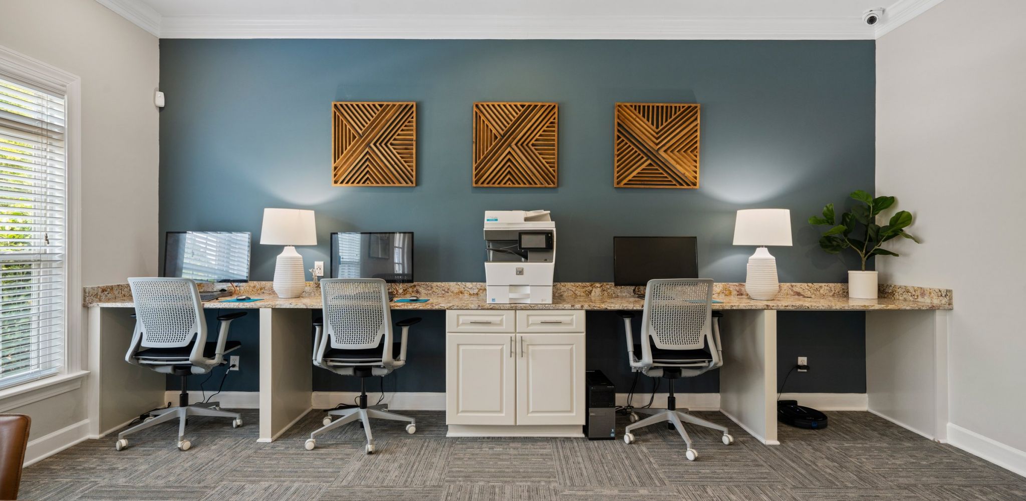 Hawthorne at the Meadows resident business center with computers, chairs, and a printer