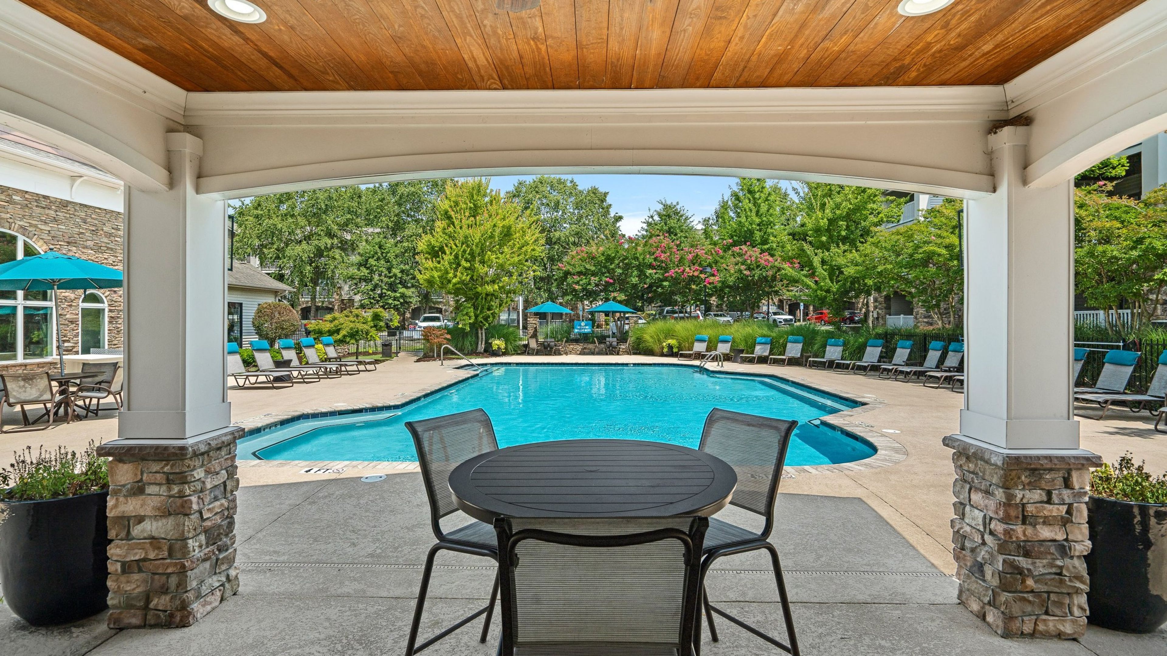 Hawthorne at the Meadows outdoor covered patio with lounge seating looking towards the outdoor pool