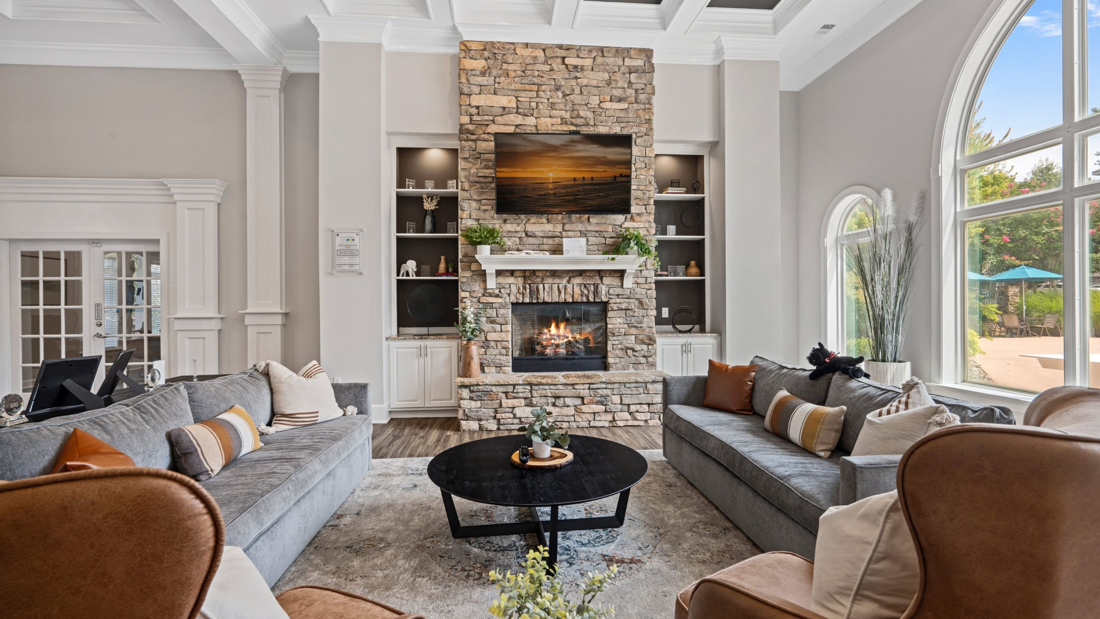 Hawthorne at the Meadows lobby lounge area with fireplace, large screen TV, and surrounding couches